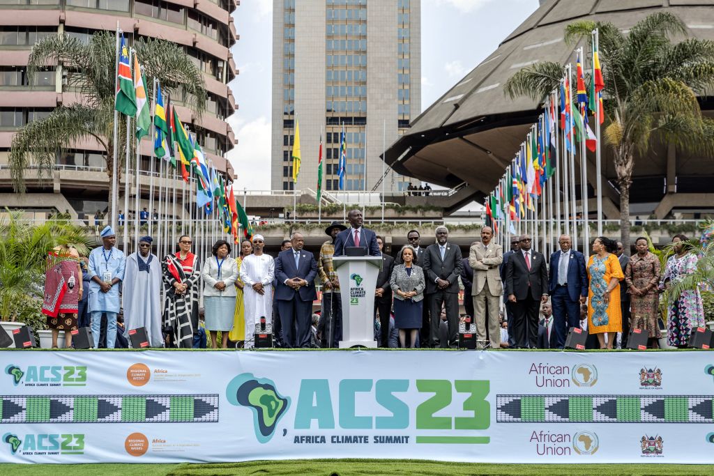 A large group of people gather on stage at the 2023 Africa Climate Conference.