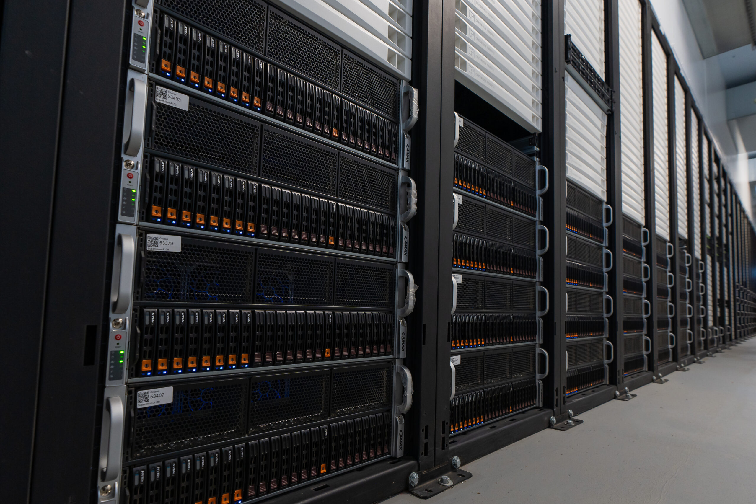 A bank of black computer servers inside a data center.