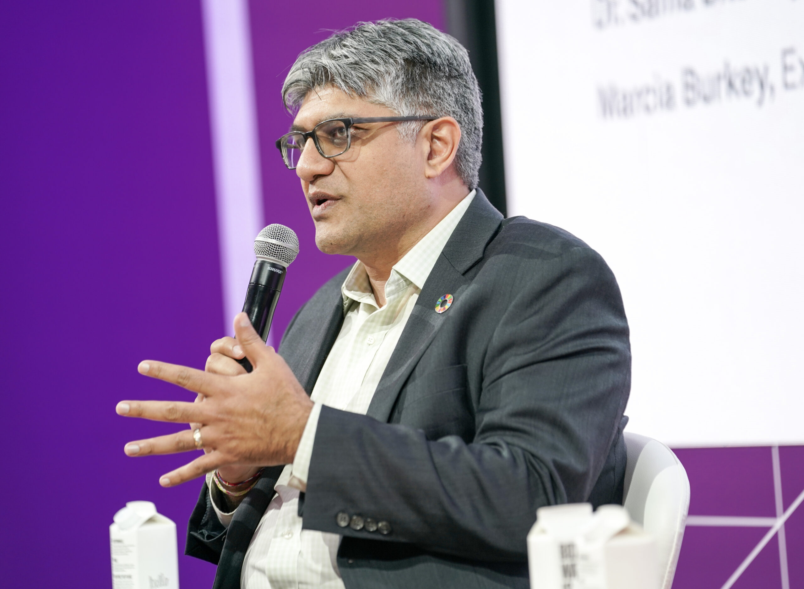 Jigar Shah, director of the U.S. Department of Energy's Loan Programs Office, seen against a purple background.