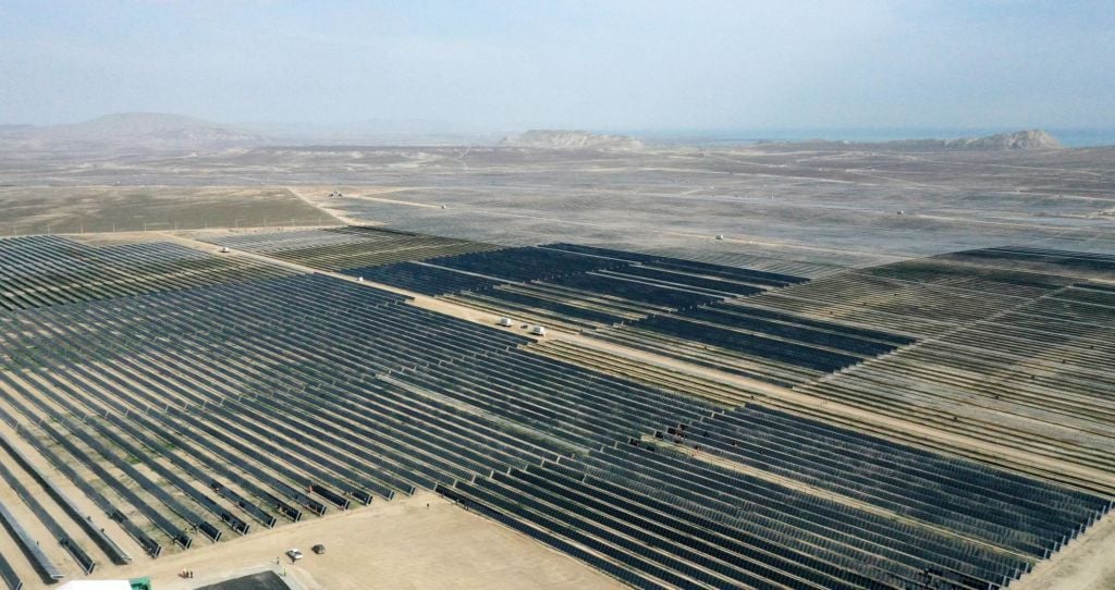 Aerial photo of a large solar power plant in a dry landscape.